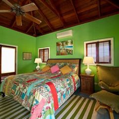 a living room filled with furniture and a bed in a bedroom