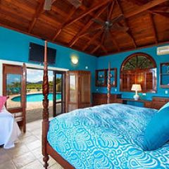 a bedroom with a bed and a chair in a room