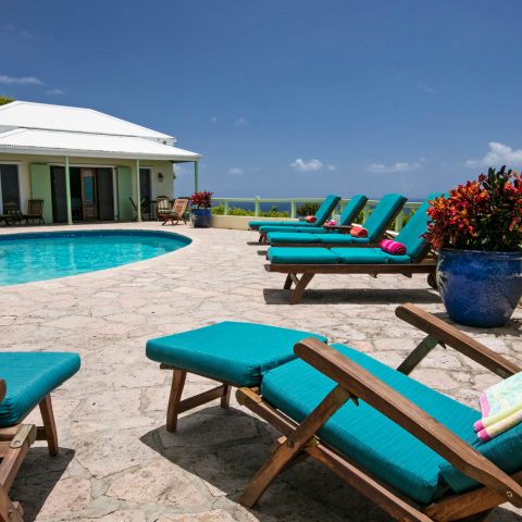 a group of lawn chairs sitting on top of a picnic table