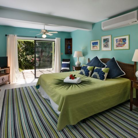 a bedroom with a bed and a chair in a room