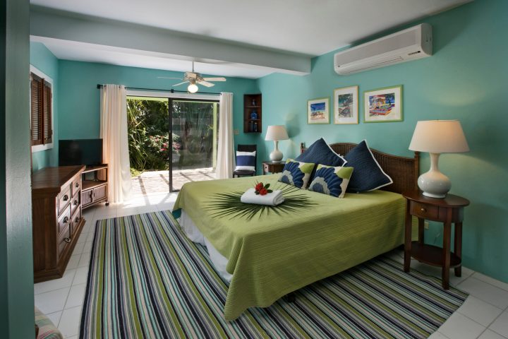 a bedroom with a bed and a chair in a room