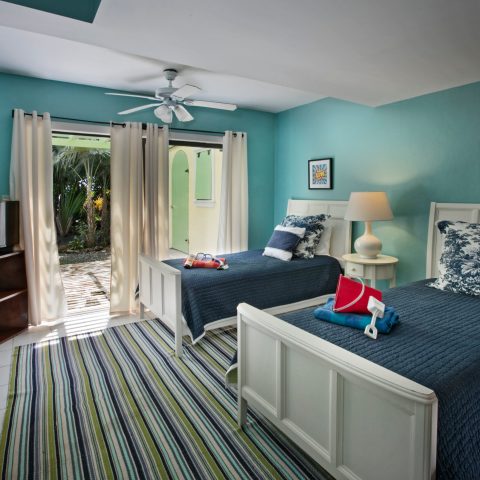 a bedroom with a bed and a chair in a room