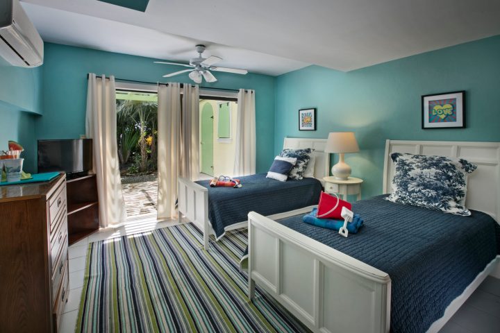 a bedroom with a bed and a chair in a room