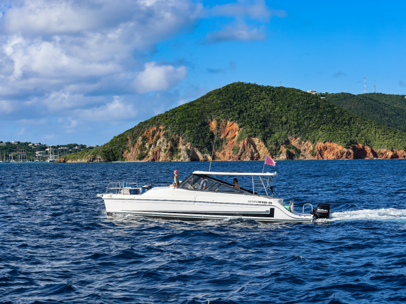 2 guests and their captain aboard Seas the Day Charters powerboat MV Hydra on St. Thomas USVI